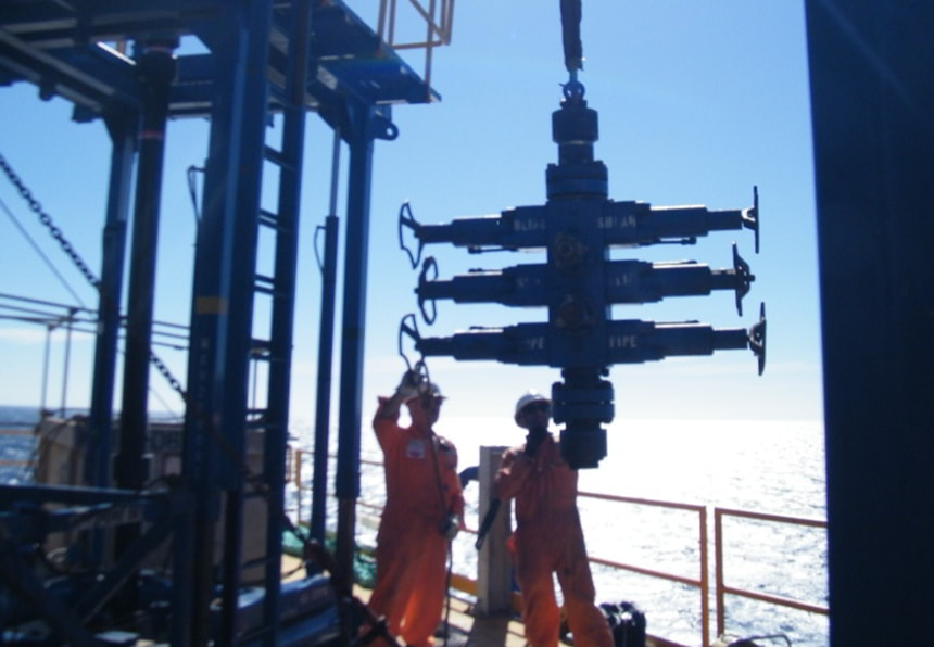 Offshore workers installing drilling equipment from Ballycatter on a platform, ensuring safe and efficient oil and gas operations.